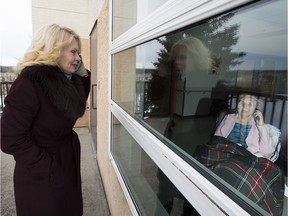 Sharon Ryan visits her mom, Louise Ryan, through the window at the Foyer Lacombe Hospice, on April 13, 2020.