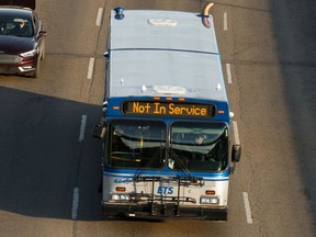 An Edmonton Transit Service bus is driven along Wayne Gretzky Drive in Edmonton, on Thursday, April 16, 2020. The City of Edmonton announced that ETS bus service would face further service reductions as ridership drops due to the COVID-19 pandemic.