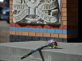 Flowers were placed outside RCMP K Division in Edmonton on Monday, April 20, 2020, for Const. Heidi Stevenson, who was killed by a gunman along with at least 18 people in Nova Scotia on April 18-19, 2020, in a senseless and random attack.