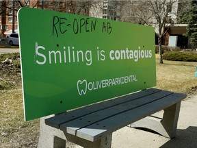 A bus stop bench on Jasper Avenue near 119 Street in Edmonton on Friday, April 24, 2020 displays signs of the pandemic times.