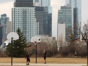 Basketball players shoot hoops at Forest Heights Park near McNally High School in Edmonton.