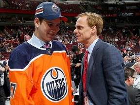 Kirill Maksimov meets with executive Scott Howson after being selected 146th overall by the Edmonton Oilers during the 2017 NHL Draft at the United Center on June 24, 2017 in Chicago, Illinois.
