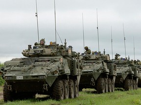 General Dynamics Land Systems Canada Lav 6 vehicles are shown carrying Canadian troops in 2016.