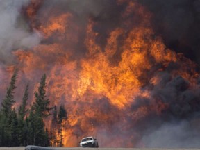 A giant fireball is seen as a wildfire rips through the forest 16 kilometres south of Fort McMurray, Alta. on Highway 63 Saturday, May 7, 2016.