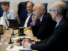 Ward 11 councillor Mike Nickel (second from right) takes part in an emergency budget meeting at City Hall, a day after the province unveiled $7 million in cuts to the city's funding, in Edmonton Friday Oct. 25, 2019.