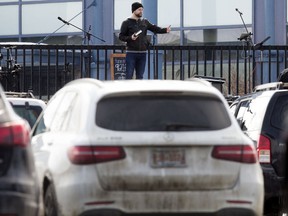 Pastor Ryan Pedde leads a Bridge Church Easter Sunday drive-in service, in the parking lot outside the Fort Saskatchewan Dow Centennial Centre Sunday April 12, 2020.