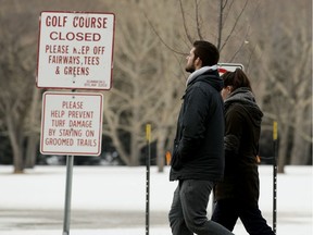 Pedestrians walk through the closed Victoria Golf course, in Edmonton Thursday April 9, 2020. Photo by David Bloom