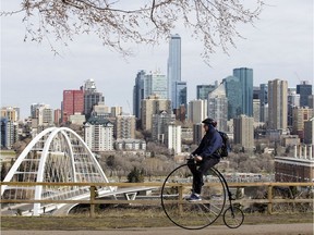 A cyclist rides a penny-farthing bicycle along along Saskatchewan Drive near 106 Street, in Edmonton Monday April 27, 2020. Photo by David Bloom