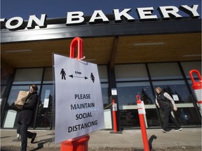 Customers observe COVID-19 social distancing while shopping at the Bon Ton Bakery, 8720 149 St., in Edmonton Saturday April 18, 2020