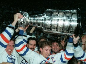 Edmonton Oilers captain Wayne Gretzky hoists the Stanley Cup after beating the Philadelphia Flyers in Game 7 of the Stanley Cup finals to win their third Stanley Cup Championship at the Northlands Coliseum on May 31, 1987, in Edmonton.
