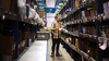 Heather Cochrane works in one of the many aisles of products and supplies stored at the East Lake Centre in Calgary. Photo credit: Kerianne Sproule