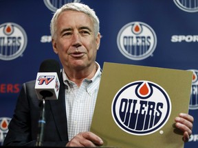 Oilers Entertainment Group CEO Bob Nicholson holds up a NHL draft card as he speaks about the Edmonton Oilers winning the draft lottery and selecting top prospect Connor McDavid during a press conference at Rexall Place in Edmonton on April 20, 2015.
