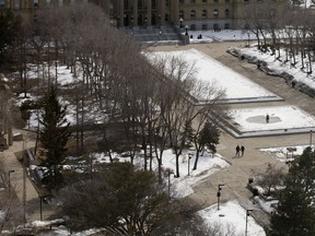 A couple walks through the empty grounds at the Alberta Legislature, in Edmonton Wednesday April 8, 2020. On Wednesday Alberta Premier Jason Kenney released the Province's COVID-19 projection modelling.