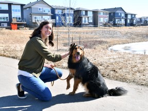 Julie Giacobbo, along with her dog Charlie, take a walk on a foot path in the Uplands at Riverview.