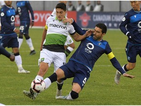 York 9 midfielder Manuel Apricio (10) battles for the ball with FC Edmonton defender Ramon Soria Alonso (5) on June 5, 2019, in the first half of a Canadian Championship soccer match at York University Field.