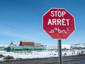 A stop sign in English, French and Inuit is seen in Iqaluit, Nunavut on April 25, 2015.