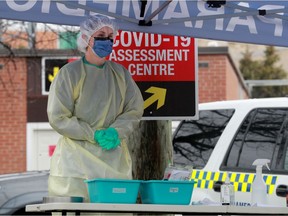 Nurses take COVID-19 swabs at a drive-through testing site outside the Almonte General Hospital recently.