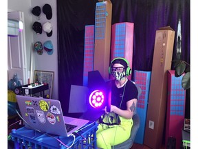 Niuboi, one of the performers in Tracks, sets up their home with all the technology necessary for the virtual play, including a backdrop of Winnipeg.