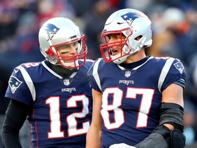 Tom Brady of the New England Patriots reacts with Rob Gronkowski during the third quarter in the AFC Divisional Playoff Game against the Los Angeles Chargers at Gillette Stadium on January 13, 2019 in Foxborough, Massachusetts.