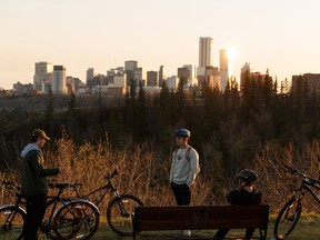 Three cyclists chat at sunset at 75 Street and Ada Boulevard in Edmonton, on Monday, May 4, 2020. With warmer weather, more Edmontonians are exercising outside during the COVID-19 pandemic lockdown.