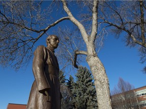 Statue of Brother Anthony Kowalczyk at the Virgin Mary grotto on the U of A's Campus Saint-Jean. Brother Anthony built the stone structure in 1944-45 with stones from the Mill Creek ravine nearby.