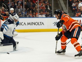 Edmonton Oilers Gaetan Haas (91) is stopped by Winnipeg Jets' goaltender Connor Hellebuyck (37) during first period NHL hockey action at Rogers Place in Edmonton, on Saturday, Feb. 29, 2020.