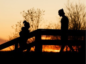 Runners exercise on river valley stairs that the City of Edmonton says are closed to repetitive exercise due to the COVID-19 pandemic at Constable Ezio Faraone Park in Edmonton, on Thursday, April 30, 2020.