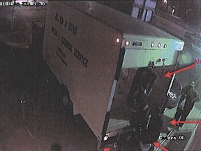 A surveillance image included in a court exhibit showing a group of men, including Jean Musoni (in truck bed) and Roger Rurangwa (on loading dock) carrying Aldane Mesquita into an Edmonton apartment where he was tortured over a drug debt before his death. His body was found in the back of the truck on Sept. 13, 2018.