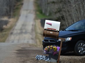 A memorial at the Strathcona County home where mom Lois Paterson-Gartner and daughter Sarah, 13, were allegedly killed by Greg Gartner, their husband and father. Gartner then took his own life.