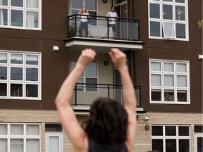 Ty Khan with F.R.E.E. Fit leads a workout for condo residents and the public at Glenora Gates in Edmonton, on Thursday, May 7, 2020. The event was their fourth balcony workout in the region.
