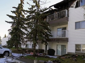 Fire damage can be seen on the top floor of Beaumaris Court, 10405 155 Ave., a three-storey residential apartment in northwest Edmonton, on Wednesday morning, May 13, 2020. Fire investigators on scene say it was possibly started by a burning cigarette. Two apartment units were heavily damaged by the morning fire.