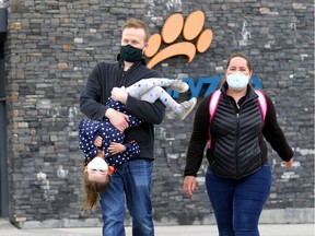 Parents, Matt and Tia Bell with daughter, Emerald,4, leave the Calgary Zoo as it opened in Calgary on Saturday, May 23, 2020.