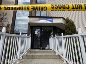Police tape blocks the smashed front entrance to the Callingwood On 170th Apartments at 17004 64 Ave. in Edmonton on Thursday, May 14, 2020. The Alberta Serious Incident Response Team (ASIRT) is investigating after a man sustained life-threatening injuries after he jumped or fell from a fourth floor balcony during an arrest by Edmonton police at the Callingwood On 170th Apartments.
