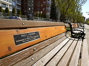 Memorial plaques on benches on Victoria Promenade in downtown Edmonton are being replaced by the City of Edmonton after thieves removed some of them over the winter. (Photo by Larry Wong/Postmedia)