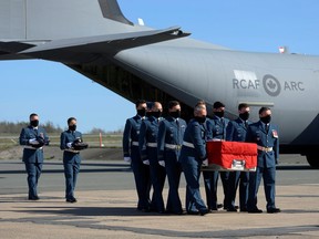 Pallbearers carry the flag-draped casket of Captain Jennifer Casey, who was killed in the crash of a Royal Canadian Air Force Snowbirds exhibition team aircraft, during a homecoming ceremony in Halifax, Nova Scotia, Canada May 24, 2020. REUTERS/Darren Calabrese