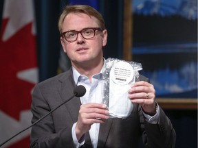 Alberta Minister of Health Tyler Shandro holds a package of four non-medical masks that will be available to Albertans to prevent the spread of COVID-19, May 29, 2020.