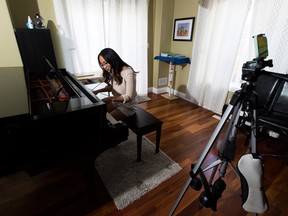 Anna Zhang is raising money for Alberta's food banks during the COVID-19 pandemic by taking song requests from the public that she covers and posts. Taken at her home in Sherwood Park, Alta., on May 16, 2020.