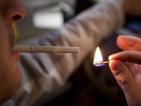 A cigarette is lit inside a car in Edmonton, Alta. File photo.