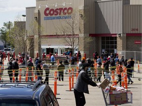 Shoppers wait in line outside the Mill Woods Costco, 2616 91 St., in Edmonton Saturday May 23, 2020.