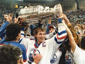 Edmonton Oilers team captain Wayne Gretzky holds up the Stanley Cup trophy following the Oilers 3-1 victory in the seventh game of the Stanley Cup finals in Edmonton on June 1, 1987.
