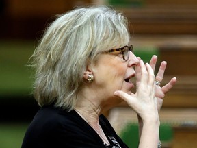 Canada's Green Party parliamentary leader Elizabeth May mimics wearing a face mask before a meeting of the special committee on the COVID-19 pandemic, as efforts continue to help slow the spread of the coronavirus disease (COVID-19), in the House of Commons on Parliament Hill in Ottawa, Ontario, Canada April 29, 2020.