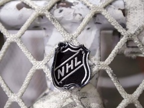 In this file photo taken Sept. 17, 2012, the NHL logo is seen on a goal at a Nashville Predators practice rink in Nashville, Tenn.