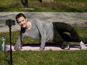 Personal trainer Malory Hodge works out at Paul Kane Park in Edmonton on May 15, 2020. She trains people remotely from her home.