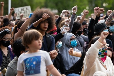 Demonstrators kneel during the A Fight for Equity rally on the grounds of the Alberta Legislature in Edmonton, on Friday, June 5, 2020. The demonstration follows worldwide Black Lives Matter protests set off by the May 25 death of George Floyd in Minneapolis, Minnesota. Police officer Derek Chauvin has been charged with murder after Floyd died during an arrest where Chauvin knelt on his neck for nine minutes. Photo by Ian Kucerak/Postmedia