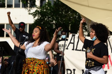 Artist and singer Sierra Jamerson (left) speaks and sings during the A Fight for Equity rally at the Alberta Legislature in Edmonton, on Friday, June 5, 2020. Photo by Ian Kucerak/Postmedia
