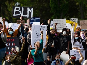Demonstrators cheer during the A Fight for Equity rally at the Alberta legislature in Edmonton on June 5, 2020. The demonstration follows worldwide Black Lives Matter protests set off by the May 25 death of George Floyd in Minneapolis, Minnesota.
