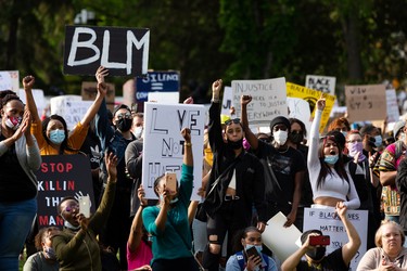 Demonstrators cheer during the A Fight for Equity rally at the Alberta Legislature in Edmonton, on Friday, June 5, 2020. The demonstration follows worldwide Black Lives Matter protests set off by the May 25 death of George Floyd in Minneapolis, Minnesota. Police officer Derek Chauvin has been charged with murder after Floyd died during an arrest where Chauvin knelt on his neck for nine minutes. Photo by Ian Kucerak/Postmedia