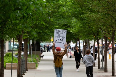 A skateboarder shows a Black Lives Matter sign as demonstrators leave the A Fight for Equity rally at the Alberta Legislature in Edmonton, on Friday, June 5, 2020. Drivers honked their horns as demonstrators called out for equality and justice. Photo by Ian Kucerak/Postmedia