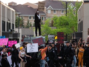 Demonstrators protest at 109 Street and Jasper Avenue after leaving the A Fight for Equity rally at the Alberta legislature in Edmonton on Friday, June 5, 2020. Drivers honked their horns as demonstrators called out for equality and justice.