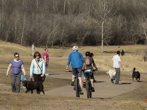 Cyclists and dog walkers meet in a warm spring afternoon in Dawson Park in Edmonton, on Monday, April 23, 2018.